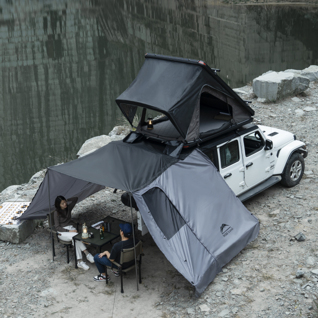 Car rooftop tent setup with awning and camping setup by Wild Land